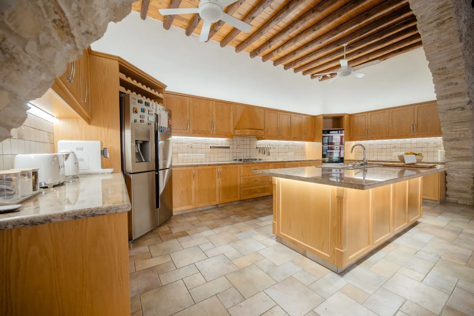 The kitchen through the stone arch