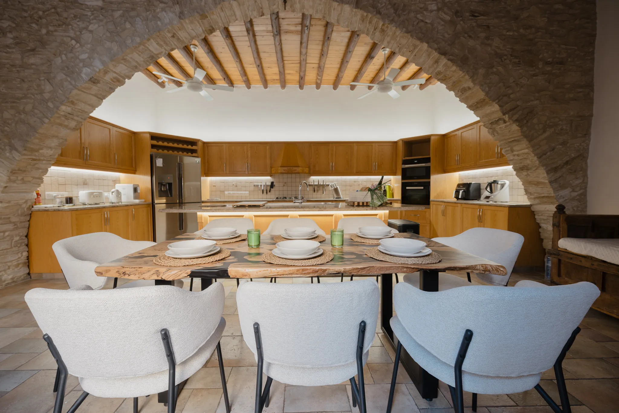 The kitchen and dining table through the stone arch