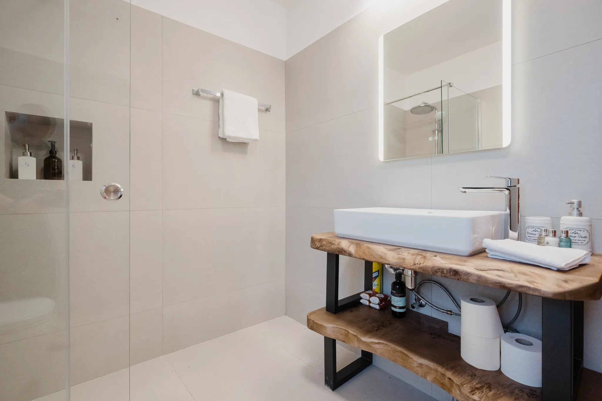 Walk-in shower and olive-wood vanity