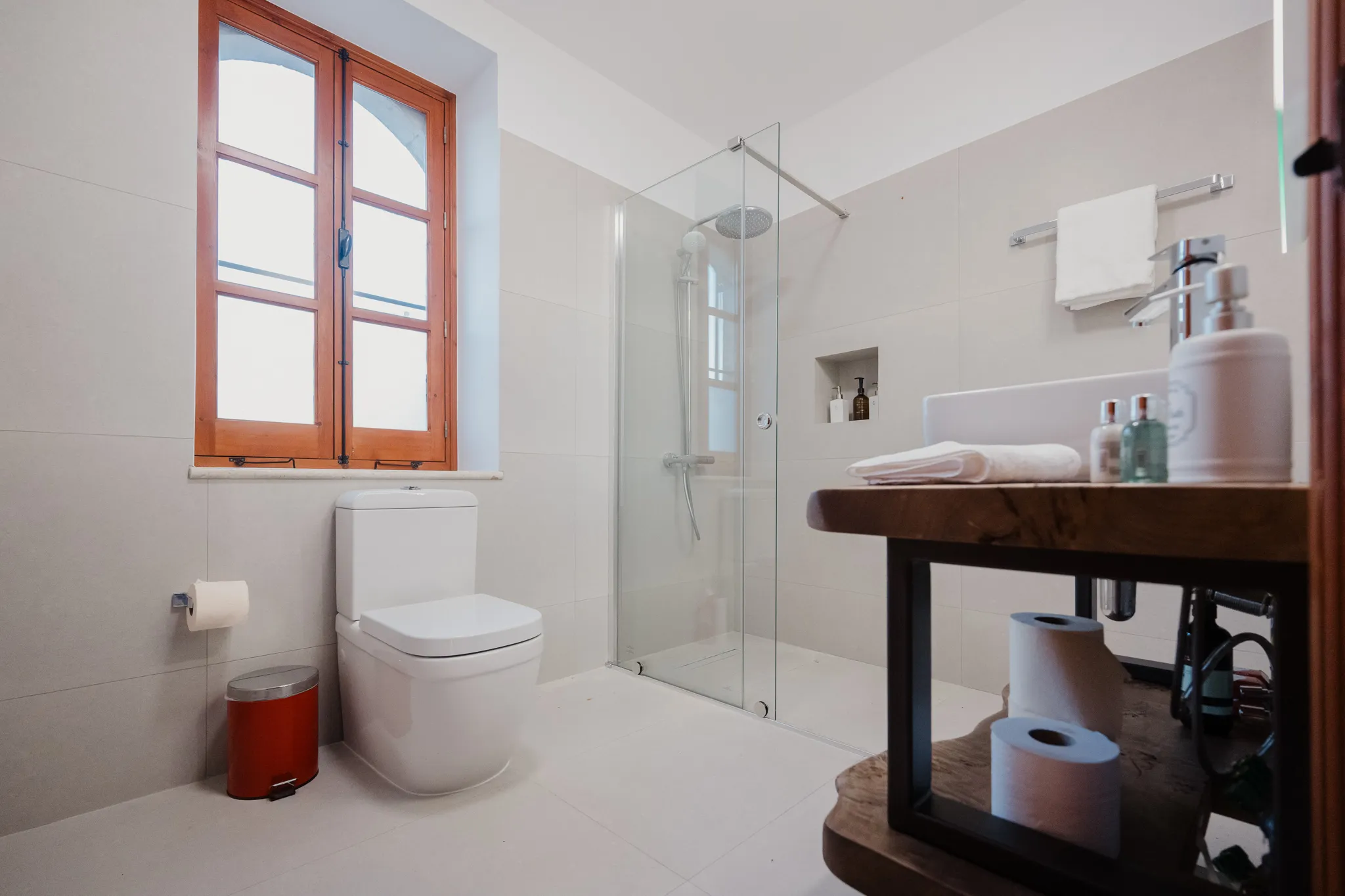 A bathroom with a walk-in rain shower