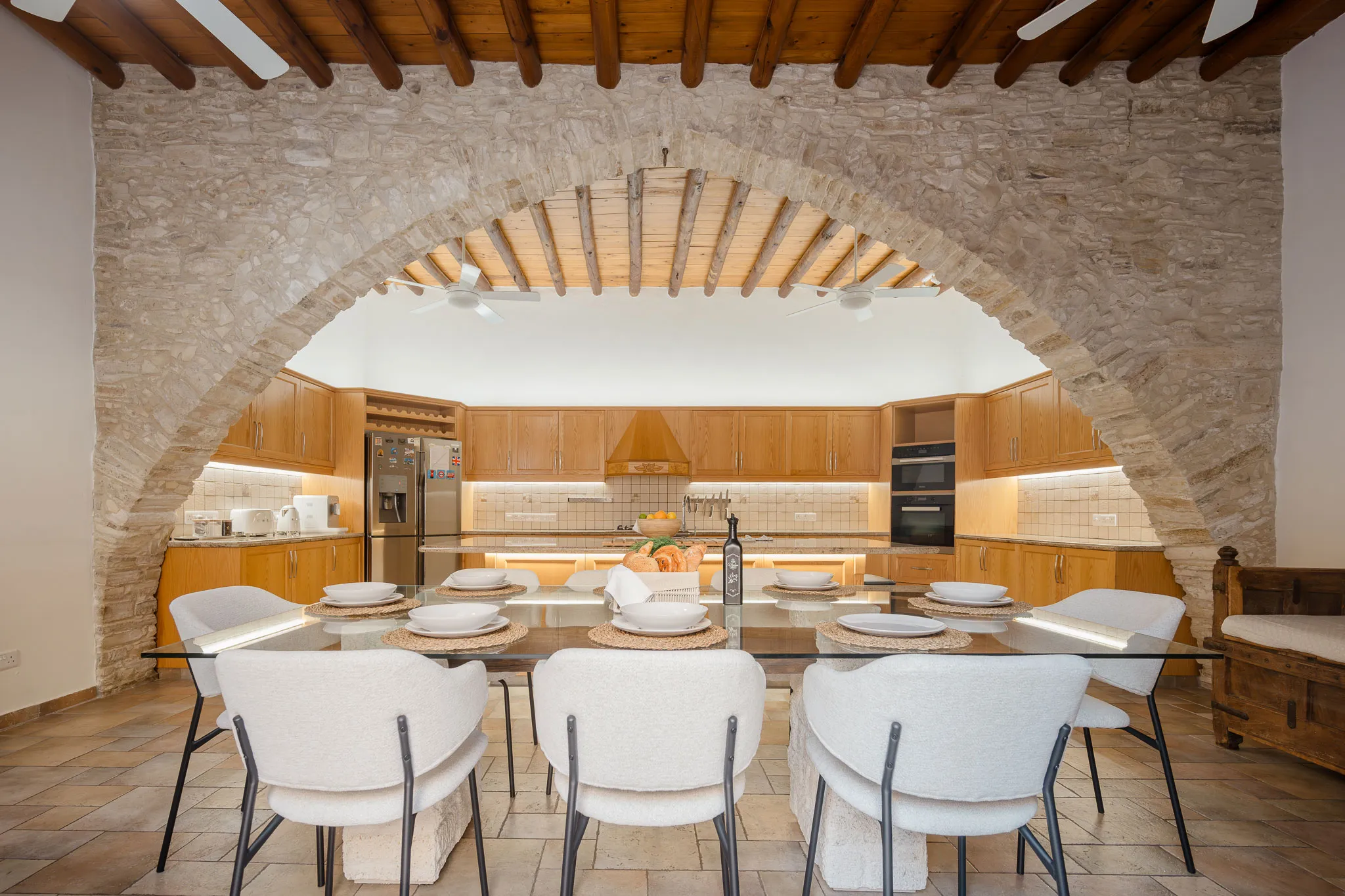 The kitchen and dining table seen through the stone arch
