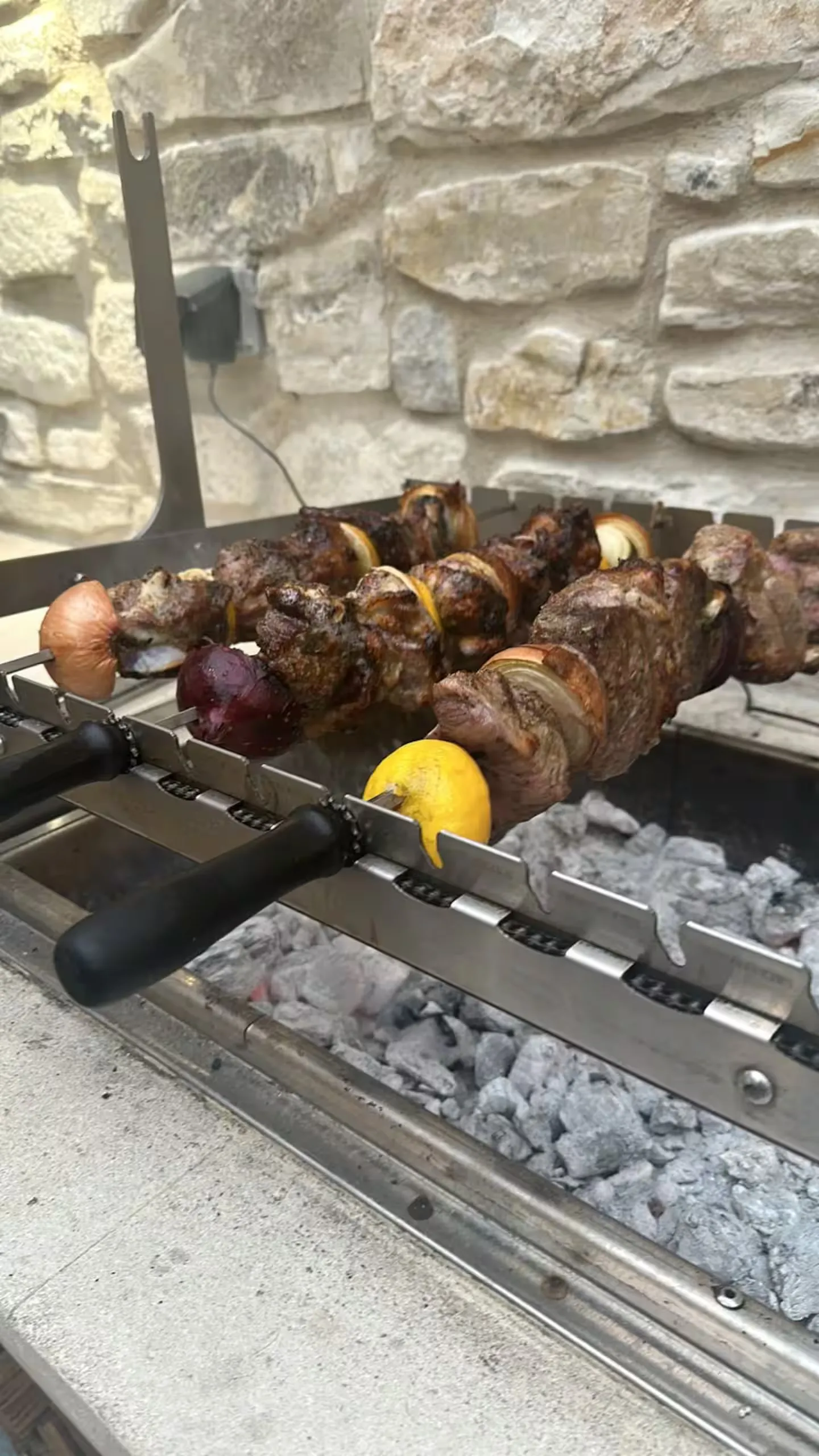 Souvla skewers turning on the grill