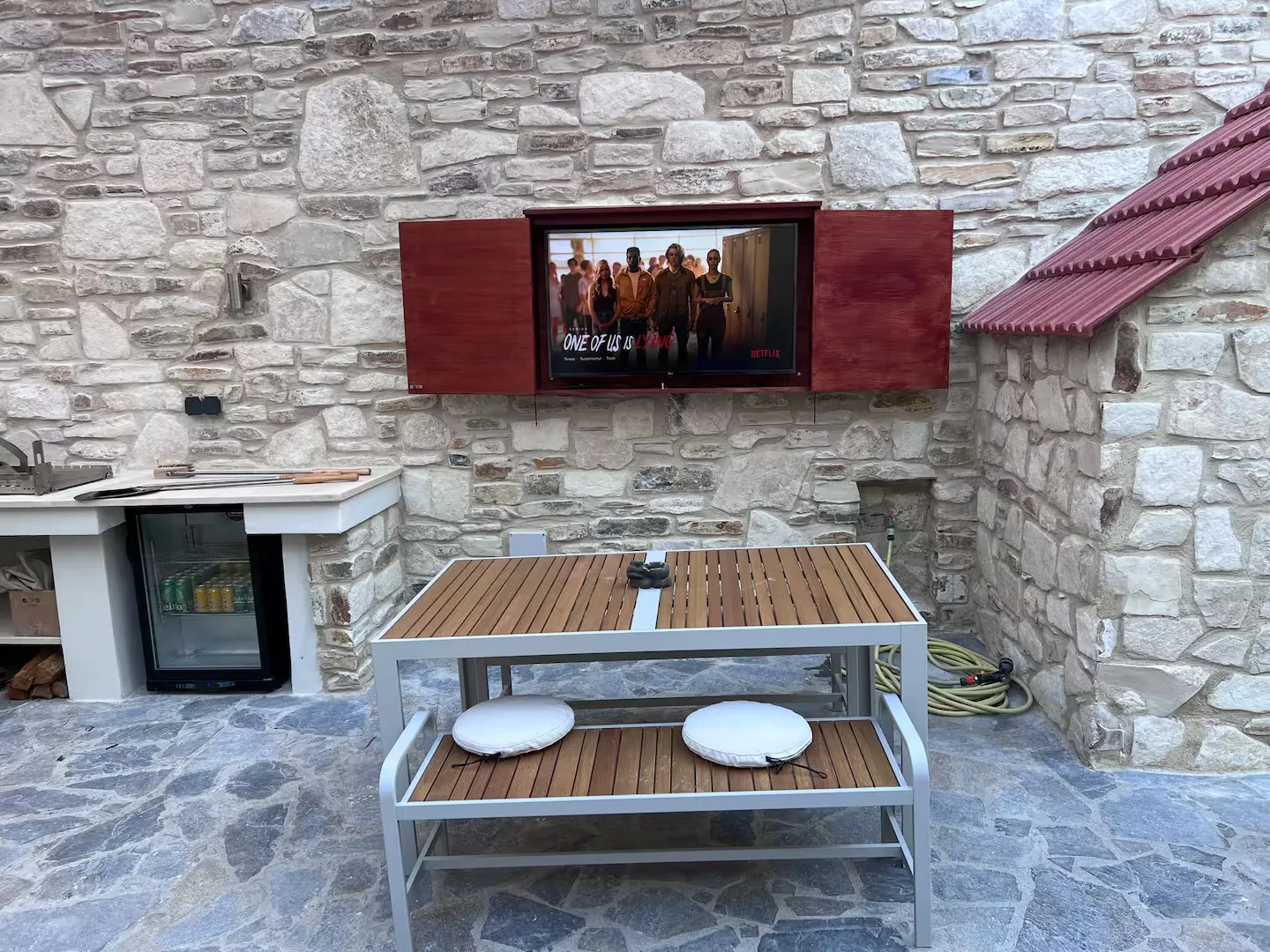 The outdoor television and drinks fridge