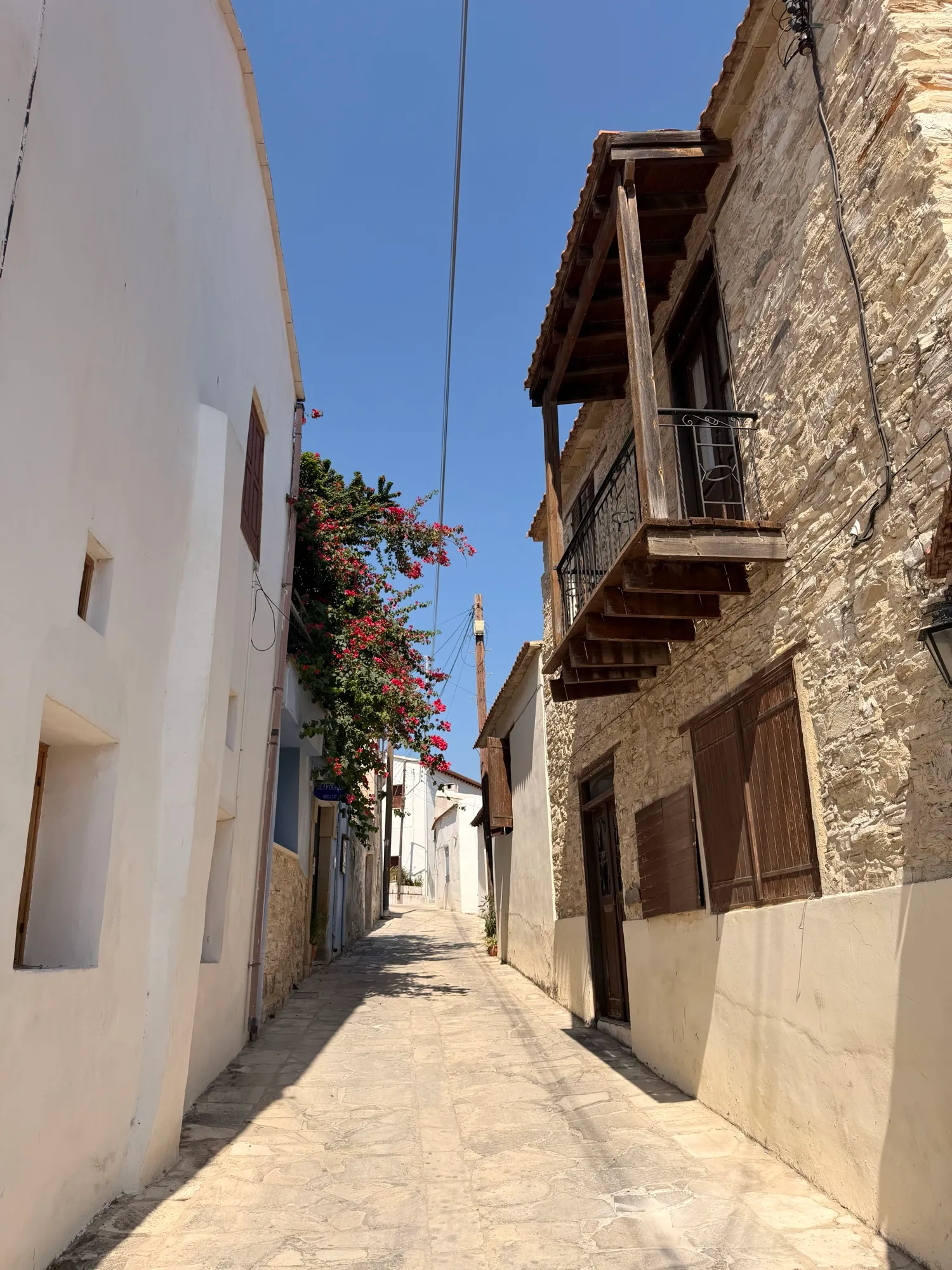 A village lane draped in bougainvillea