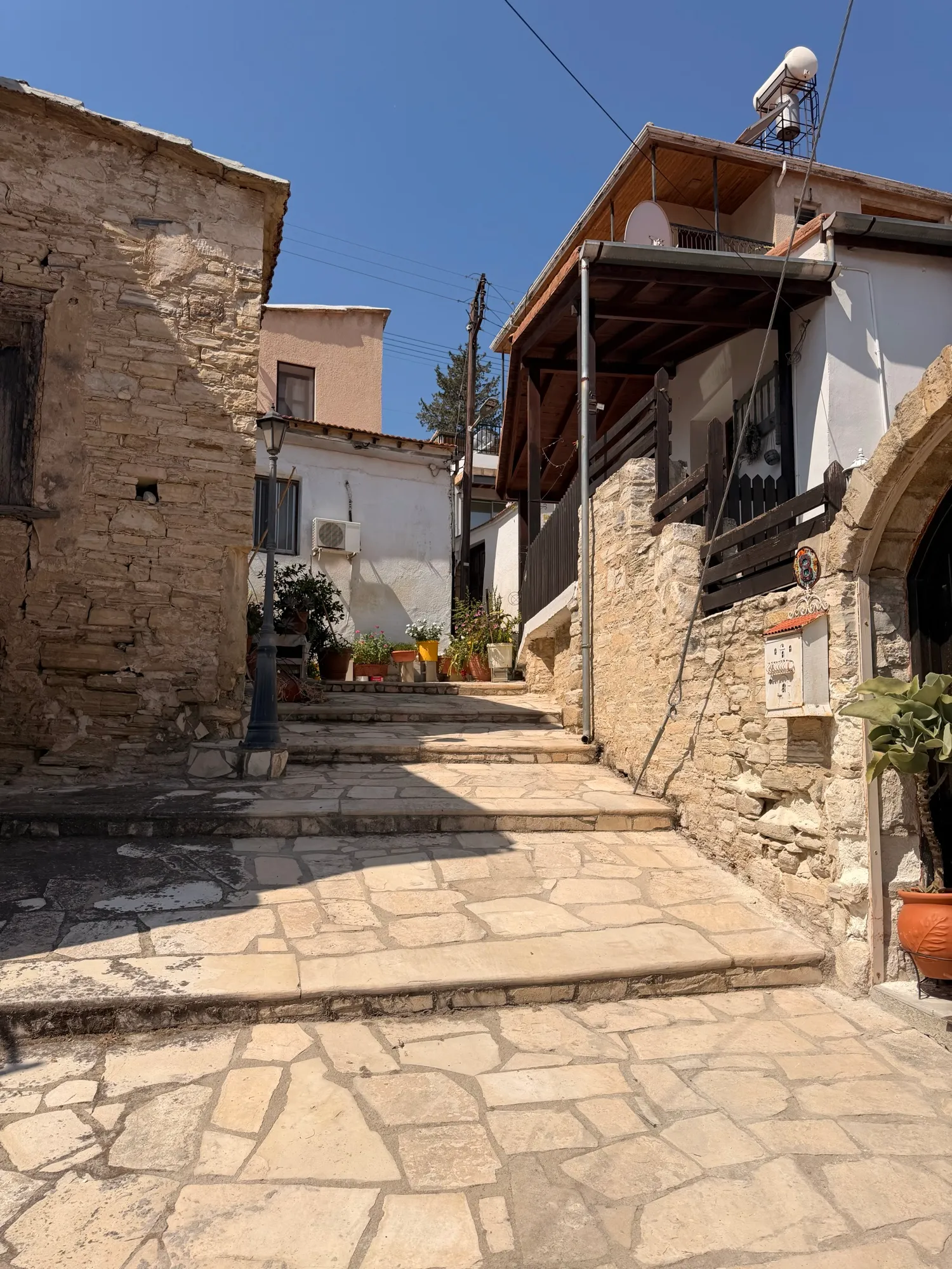 A flagstone lane with an old lamppost