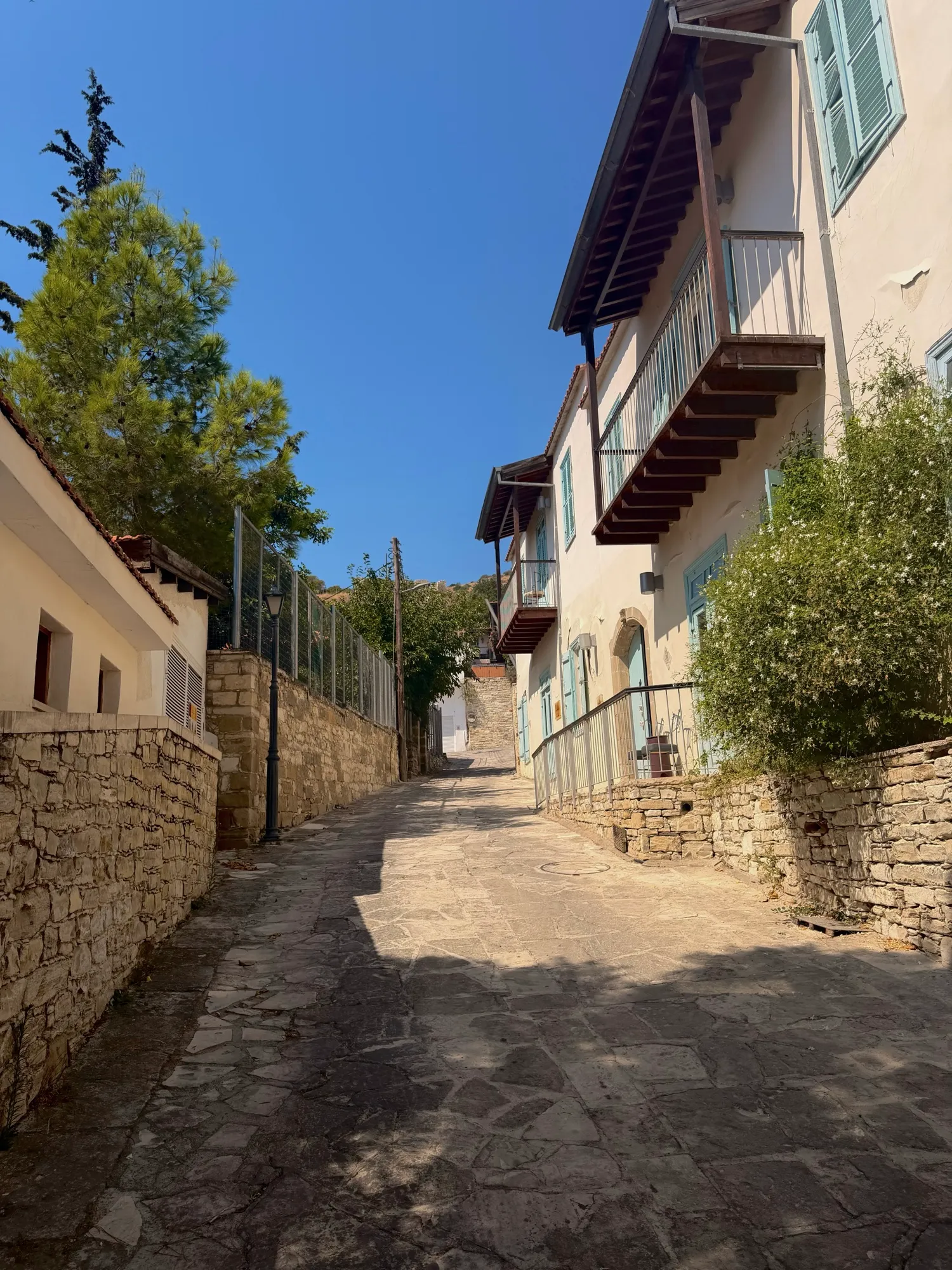 A sloping stone lane with wooden balconies