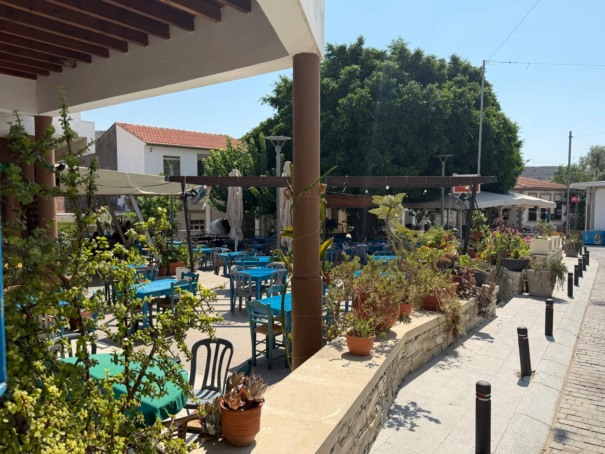 Blue taverna tables on the village square